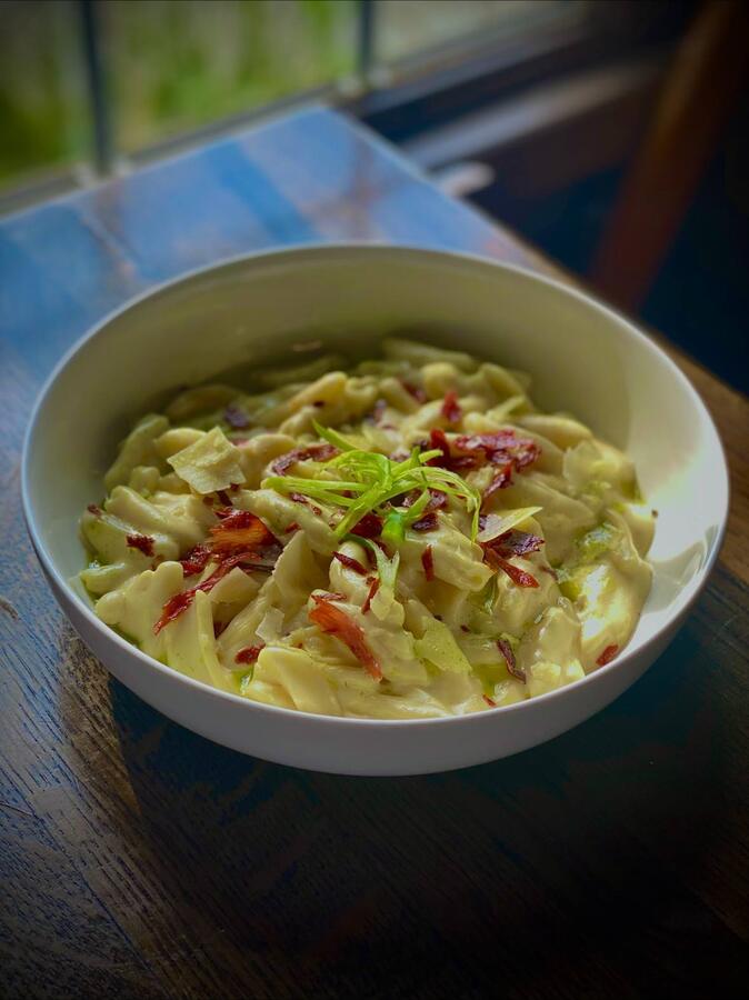 Creamy pasta with crispy cured meat and herbs